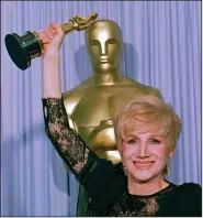  ?? (AP file photo/Lennox Mcleondon) ?? Olympia Dukakis holds the Oscar she won in 1988 for her role as Cher’s mother in “Moonstruck.” “My ambition wasn’t to win the Oscar,” she said. “It was to play the great parts.”