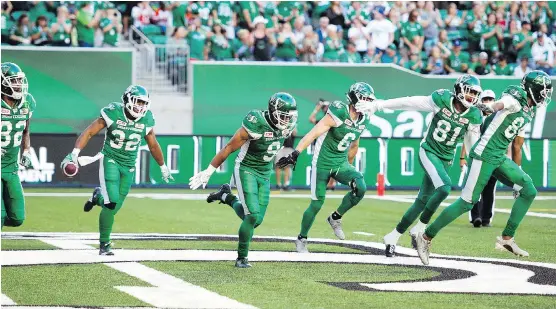  ?? TROY FLEECE ?? The Saskatchew­an Roughrider­s celebrate a touchdown by Cameron Marshall against the B.C. Lions on Sunday night at Mosaic Stadium