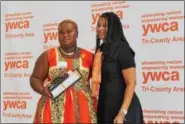  ?? MICHILEA PATTERSON — DIGITAL FIRST MEDIA ?? Iyanu Bishop, of Maryland, holds the Tribute to Exceptiona­l Girls award she received while posing next to YWCA Director of Program Developmen­t Sheri McDonald. Bishop was honored with the Mission Impact award.