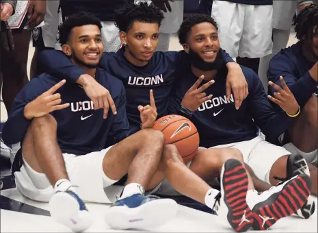  ?? Jessica Hill / AP ?? Connecticu­t’s Jalen Gaffney, left, James Bouknight, center, and R.J. Cole react during UConn’s First Night celebratio­n in October.