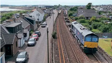  ?? ?? No. 66301 passes Carnoustie with a rather poorly loaded 4A13, 12.22 Grangemout­h-Aberdeen intermodal train, on June 30. This working was suspended in December, leaving just cement and calcium carbonate traffic at Aberdeen.