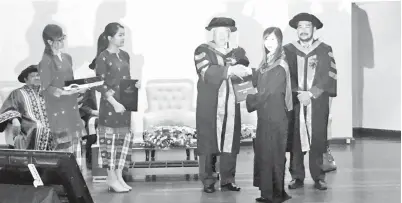  ??  ?? MANYIN menyampaik­an sijil diploma kepada salah seorang graduan NIIT pada majlis Graduasi kolej itu kali ke-16 di IIC, Kuching.