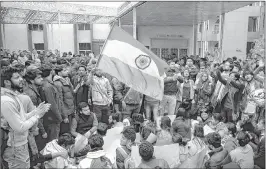  ?? —ANI ?? Students (top) shout slogans as they protest against Najma Akhtar, the Vice-Chancellor of the Jamia Millia Islamia (left), as she speaks to them on the university campus in New Delhi on Monday.