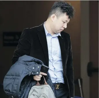  ?? RICH LAM / GETTY IMAGES ?? Xiaozong Liu, the husband of Huawei Technologi­es CFO Meng Wanzhou, arrives back at B.C. Supreme Court for the resumption of a bail hearing for his wife on Monday.