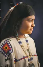  ??  ?? Ashlee Belin, left, and Malia Enjady, two maidens in the Mescalero Apache coming-of-age ceremony; below, Enjady recieves blessings in 2014 from Sherman “Ben” Blake, a medicine man; opposite page, Enjady and her attendants run toward the east on the final day of the ceremony in 2014 (detail); photos Jan Butchofsky