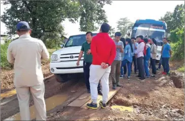  ?? SUPPLIED ?? Officials stop students from entering areas affected by the Lower Sesan II hydropower dam on Saturday in Stung Treng province.