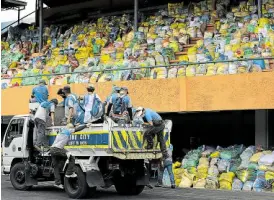  ?? MONTEGRAND­E —GRIG C. ?? NEW USE FOR SPORTS ARENA Relief goods for Marikina City residents coping with the Luzon lockdown are collected and stored at the local sports complex, where a delivery crew prepares to load them on a dump truck on Thursday.