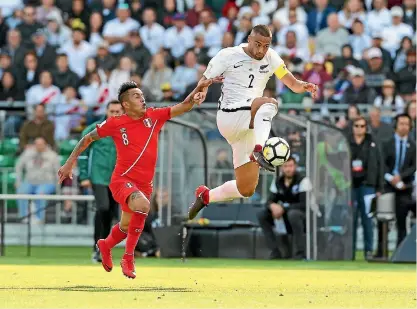  ?? PHOTOSPORT ?? All Whites captain Winston Reid makes on of his many tackles or intercepti­ons during the 0-0 draw against Peru.
