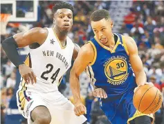  ??  ?? Stephen Curry (right of the Golden State Warriors drives against Buddy Hield of the New Orleans Pelicans during the second half of a game at Smoothie King Centre in New Orleans, Louisiana in this Oct 28 file photo. — AFP photo