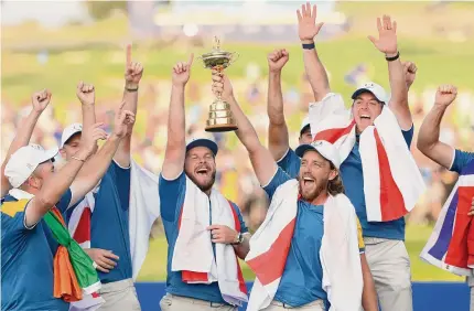  ?? Patrick Smith/Getty Images ?? Tommy Fleetwood of Team Europe lifts the Ryder Cup trophy following their win over the U.S. on Sunday in Rome.