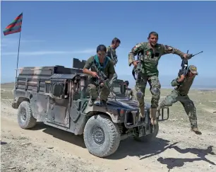  ?? — AP file ?? Afghan commandos arrive at Pandola village near the site of a US bombing in the Achin district of Jalalabad, east of Kabul, Afghanista­n.