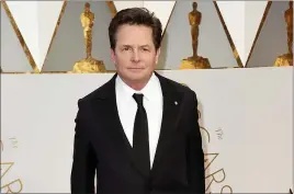  ?? ?? Michael J. Fox arrives at the Oscars on Feb. 26, 2017, in Los Angeles. Fox will receive an honorary AARP award for his work with a charity that advocates for Parkinson’s research.