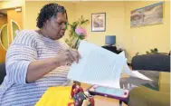  ?? ADOLPHE PIERRE-LOUIS/JOURNAL ?? Ladrene Wandick reviews the paperwork involved after a DWI vehicle seizure hearing. Her car was seized after her husband was caught driving on a revoked license.