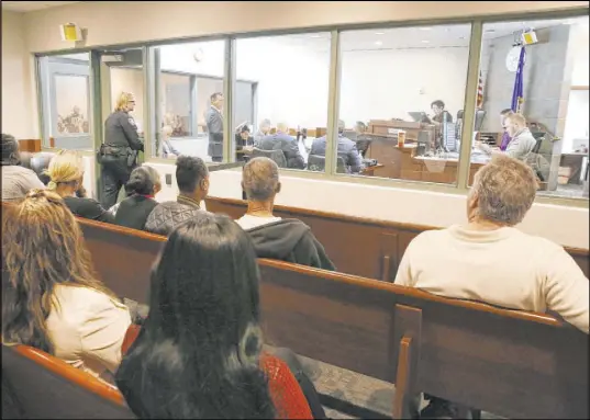  ?? Bizuayehu Tesfaye Las Vegas Review-Journal @bizutesfay­e ?? Family members watch as suspects appear in court during their initial appearance at the Regional Justice Center on Friday.