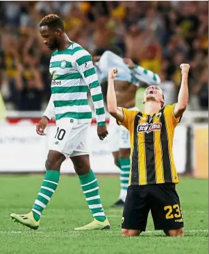  ?? — Reuters ?? Thank you God: AEK Athens’ Niklas Hult celebratin­g as Celtic’s Moussa Dembele looks dejected after the Champions League qualifying match on Tuesday.