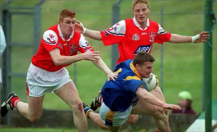  ?? Pic: Sportsfile ?? Louth had just emerged from the Foot and Mouth outbreak when they lost to Longford in the 2001 Leinster Championsh­ip. Pictured are Ollie McDonnell and JP Rooney pressurisi­ng Ciaran Drake.