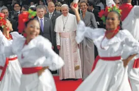  ?? Andrew Medichini / Associated Press ?? Pope Francis watches dancers perform during the pontiff ’s welcoming ceremony Wednesday at El Dorado airport in Bogota, Colombia.