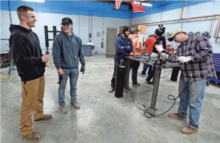  ?? ?? Payton Lane, 19, left, and Boone Williams, 20, talk during a second-year apprentice training program class at the Plumbers and Pipefitter­s Local Union 572 facility in Nashville. The union is working with young adults who graduated from high school during the pandemic and are taking career routes other than college for its apprentice program.