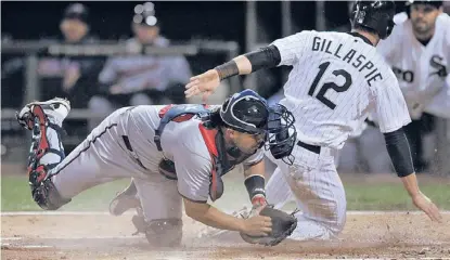  ?? | PAUL BEATY/AP ?? Conor Gillaspie slides in ahead of Twins catcher Josmil Pinto’s tag during the Sox’ seven-run first inning Monday.