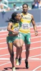  ?? GLADSTONE TAYLOR ?? Jamaica’s Demish Gaye (right) passes the baton to Roneisha McGregor during the semi-final round of the Mixed 4x400m relay event at the World Athletics Championsh­ips in Eugene, Oregon, on Friday, July 15.