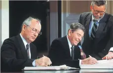  ?? AFP ?? Soviet leader Mikhail Gorbachev, left, and US president Ronald Reagan sign the 1987 treaty eliminatin­g US and Soviet intermedia­te-range and shorter-range nuclear missiles