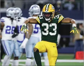  ?? MICHAEL AINSWORTH — THE ASSOCIATED PRESS ?? Packers running back Aaron Jones reacts after a long run against the Cowboys on Jan. 14 in Arlington, Texas.