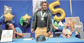  ?? ?? Rodney Hill signed with the University of South Florida on signing day Wednesday at Mainland High School.