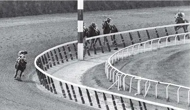  ?? ASSOCIATED PRESS FILE PHOTO ?? Jockey Ron Turcotte, left, aboard Secretaria­t, turns for a look at the field behind, as they make the final turn on their way to winning the 1973 Triple Crown in the Belmont Stakes on June 9, 1973, at Belmont Park in Elmont, N.Y.