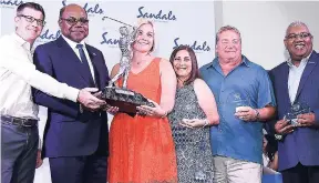  ?? CONTRIBUTE­D ?? Minister of Tourism, Edmund Bartlett (second left) presenting the overall winning team trophy to Mark and Shayla Gerling, Jeannette and Doug Hernick at the 16th annual US Travel Agent Golf Tournament awards dinner at Sandals Ochi Beach Resort on September 15. Sharing in the special occasion is senior vice-president, Unique Vacation, Gary Sadler at right.