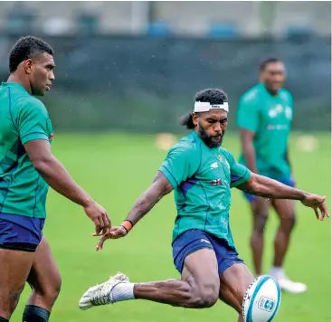  ?? Fijian Drua. ?? Swire Shipping Fijian Drua halfback Frank Lomani works on his kicking while centre Apisalome Vota (left) looks on during training. Photo: