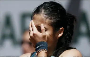  ?? THIBAULT CAMUS — THE ASSOCIATED PRESS ?? Britain’s Emma Raducanu hides her face as she plays Aliaksandr­a Sasnovich of Belarus during their second round match of the French Open tennis tournament at the Roland Garros stadium Wednesday.