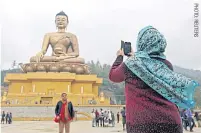  ??  ?? ABOVE
Tourists take a photo in front of Thimphu’s 54-metre-high Buddha Dordenma statue, one of the largest of its kind in the world.