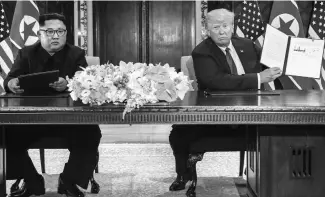  ?? PHOTO: REUTERS ?? North Korean leader Kim Jong-un ( left) with US President Donald Trump after signing the agreement in Singapore