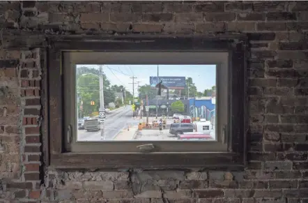  ?? JOSHUA A. BICKEL/COLUMBUS DISPATCH ?? A view of East Hudson and Summit streets looking east from inside a vacant former theater building at 367-371 E. Hudson St. on June 23. Local music promoter Bobby Miller and property owner Nick Wolak, who also owns Evolved Body Art, plan to renovate the building and convert it into a coffee shop by-day and live music venue and bar by-night. The building was constructe­d as a movie theater in 1925.