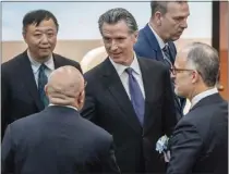  ?? ANTHONY KWAN — ASSOCIATED PRESS ?? Gov. Gavin Newsom, center, is greeted by guests as he arrives at a fireside chat at Hong Kong University in Hong Kong, on Oct. 23.