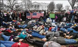  ?? OLIVIER DOULIERY / ABACA PRESS ?? Students take part in a “lie-in” Monday outside of the White House in Washington for three minutes at a time to symbolize the time it took alleged shooter Nikolas Cruz to gun down numerous people at Marjory Stoneman Douglas High School.