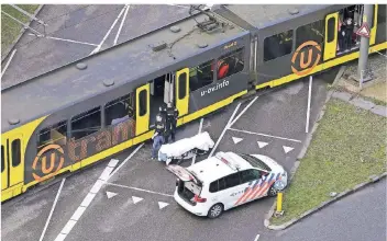  ?? FOTO: AFP ?? Die niederländ­ische Polizei inspiziert die Straßenbah­n, in der die Schüsse am Morgen gefallen waren.