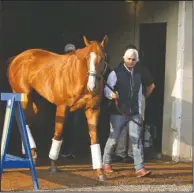  ?? The Associated Press ?? INJURY SCARE: Justify, led by trainer Bob Baffert, emerges from Barn 33 to meet the public Sunday morning after winning the 144th Kentucky Derby on Saturday at Churchill Downs in Louisville, Ky.