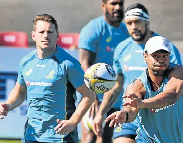  ?? Picture: AFP ?? CATCH IT: The Wallabies’ Kurtley Beale passes the ball during a training session in Sydney