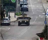  ?? (Karamallah Daher/Reuters) ?? An ARMY vehicle patrols a street in Metulla yesterday.