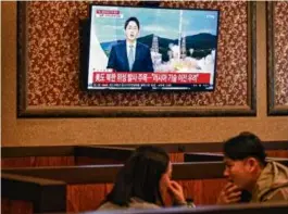  ?? ANTHONY WALLACE/AFP VIA GETTY IMAGES ?? Customers at a restaurant in Seoul. North Korea confirmed that its first spy satellite was launched into orbit Tuesday.