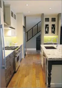  ?? Photos, Claire Young, Calgary Herald ?? The open-concept kitchen includes a hand-scraped oak floor.