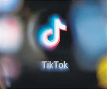  ?? Kirill Kudryavtse­v AFP/Getty Images ?? FOR TIKTOK celebritie­s, “mass-reporting” programs are a major concern. One person armed with such a tool can f lag content for violating the platform’s rules and have the videos removed and their creators banned.