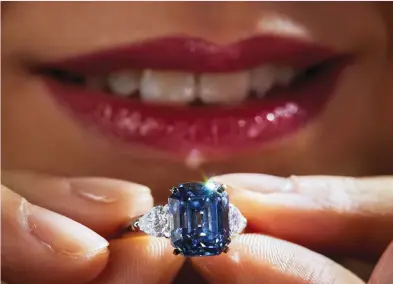  ?? (Denis Balibouse/Reuters) ?? SHOWING OFF A deep blue rectangula­r-cut diamond weighing 7.03 carats by jeweler Moussaieff, which was expected to fetch $10 to $14 million at auction, at a Christie’s preview in Geneva, 2019.