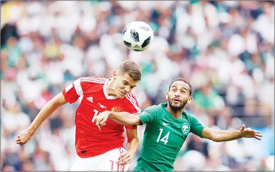  ??  ?? Russia’s Roman Zobnin (left), jumps for the ball with Saudi Arabia’s Abdullah Otayf during the Group A match between Russia and Saudi Arabia which opens the 2018 soccer World Cup at
the Luzhniki Stadium in Moscow, Russia on June 14. (AP)