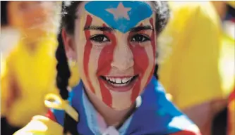  ?? MANU FERNANDEZ THE ASSOCIATED PRESS ?? A girl with her face painted with the independen­ce flag takes part in a protest in support of Catalonian politician­s who have been jailed on charges of sedition.