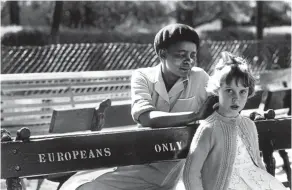  ?? Picture: Peter Magubane ?? An everyday scene during the great divide of the apartheid years — an unnamed child-minder and her charge on two sides of a bench in a Johannesbu­rg park in 1956.