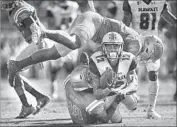  ??  ?? LINEBACKER Krys Barnes (14) and defensive back Keyon Riley bring down Hawaii’s Keelan Ewaliko.