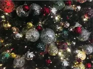  ?? Associated Press photo ?? In this Dec. 1 photo, ornaments hang on a Christmas tree on display in New York. The office holiday party is getting shaken up as reports of sexual misconduct by famous and powerful men have many companies thinking harder about how to stop bad...