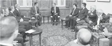  ??  ?? Assad (centre, left) speaking with Member of the National Assembly of France, Thierry Mariani, who is the president of a delegation of French parliament­arians, in Damascus. — AFP photo